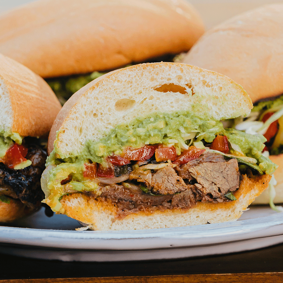 Lamb Birria Torta with Avocado, Pickled Chilis, & Ramen Consomme